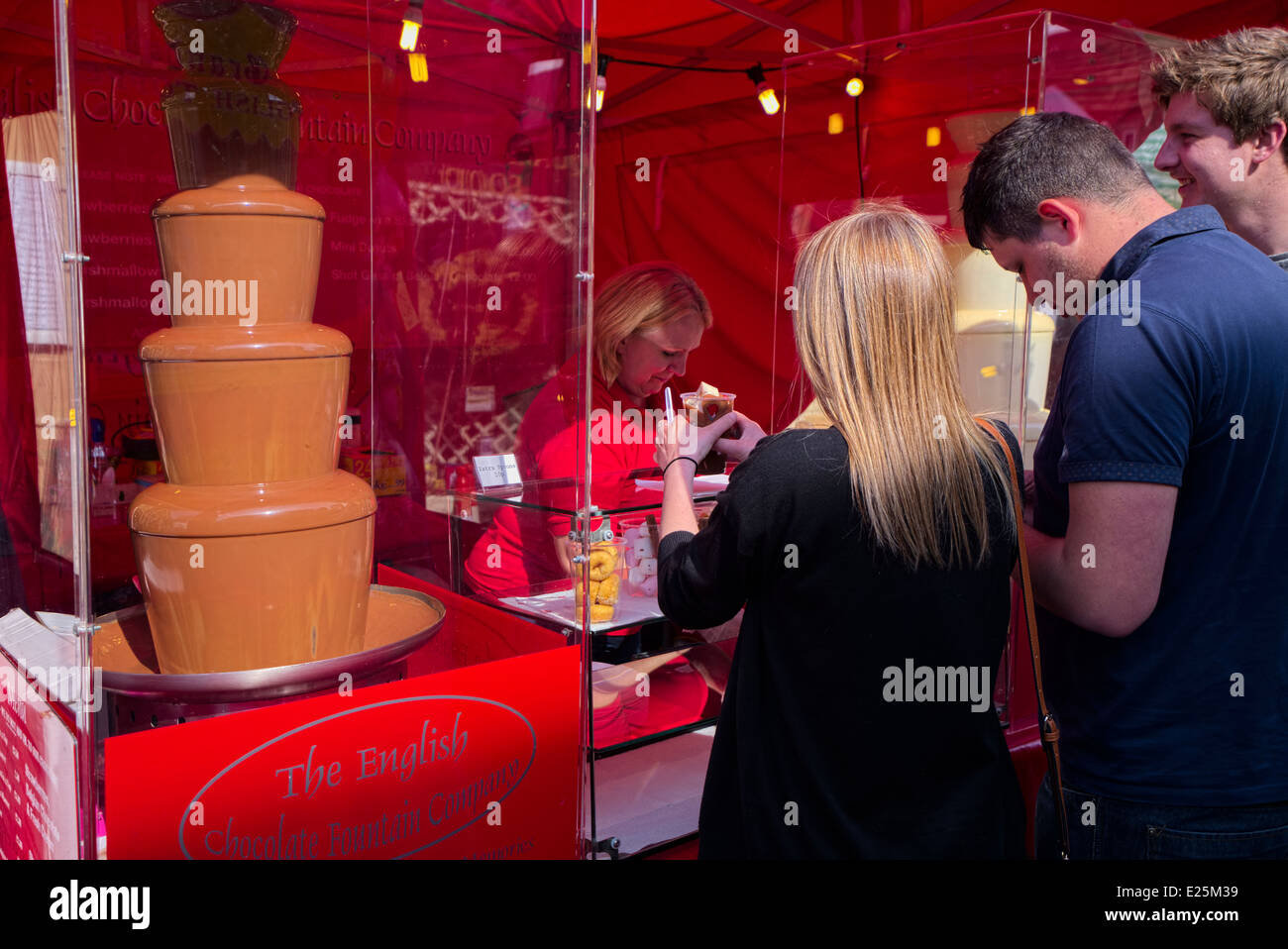 People being served at Chocolate fountain stall in Bakewell Derbyshire England Stock Photo Alamy