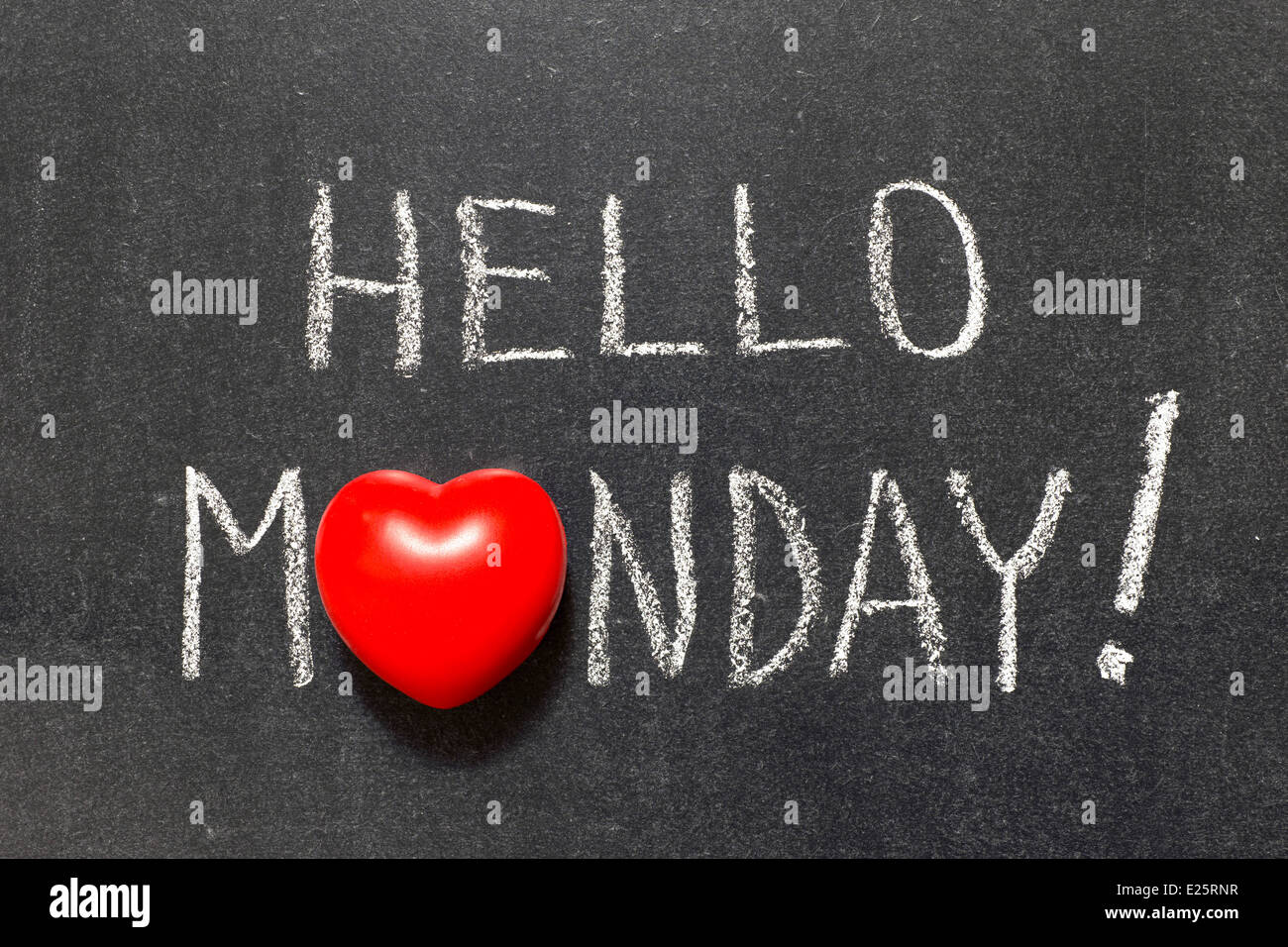 hello Monday exclamation handwritten on chalkboard with heart symbol instead of O Stock Photo