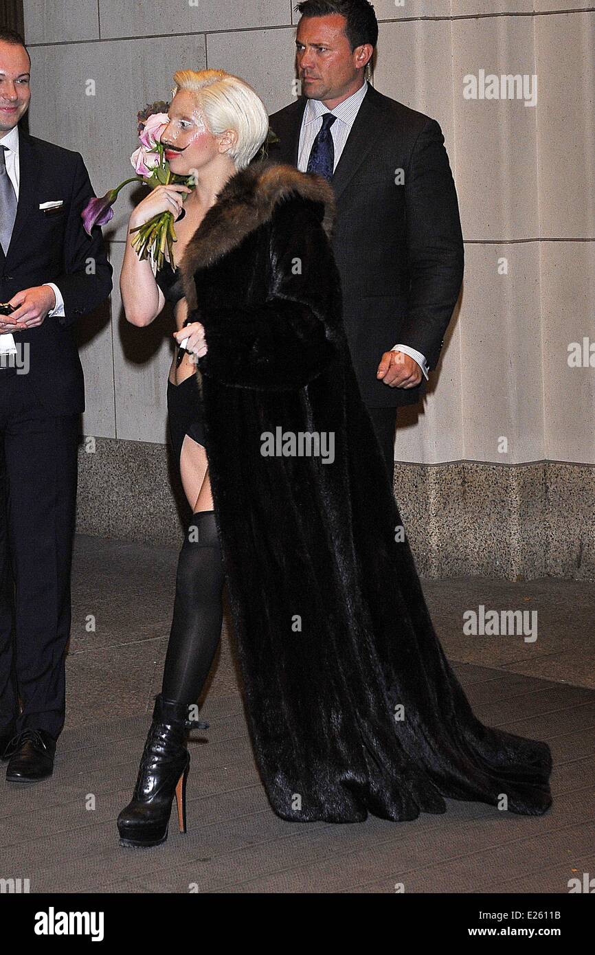 Lady Gaga arrives at her Berlin hotel in one of her bizarre costume creations, complete with a stuck on moustache  Where: Berlin, Germany When: 24 Oct 2013 Stock Photo