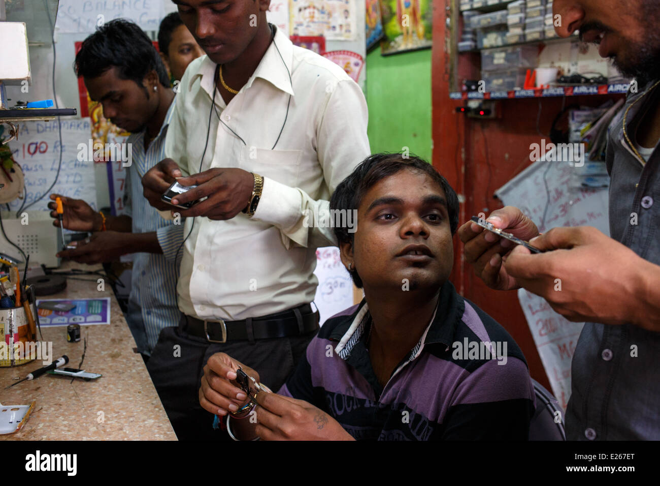 A mobile phone (cellphone) shop and repair workshop in Mumbai, India. Stock Photo