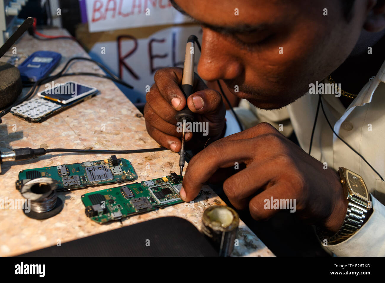A mobile phone (cellphone) shop and repair workshop in Mumbai, India. Stock Photo