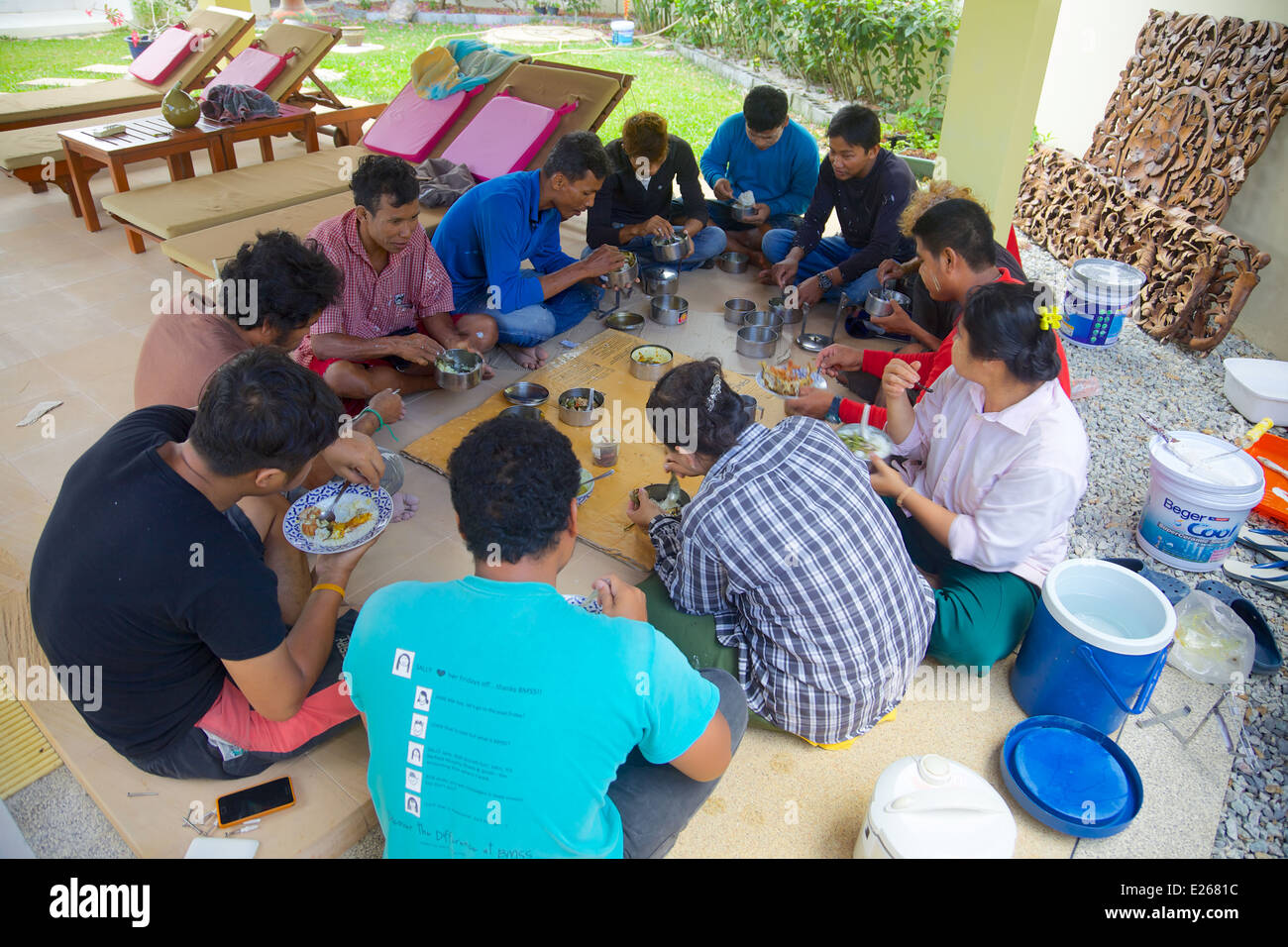 Burmese workers having lunch, Phuket Thailand Stock Photo
