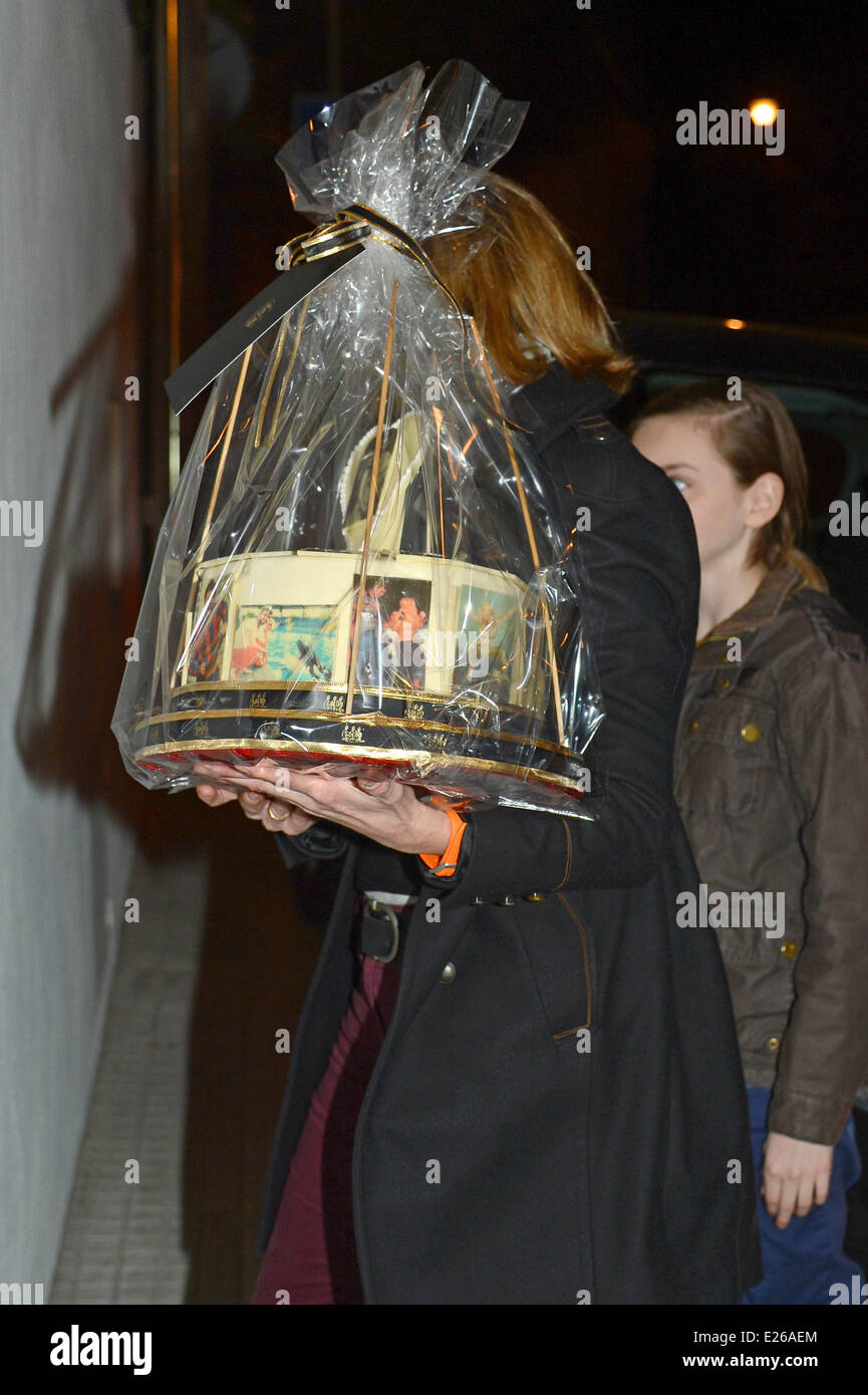 A birthday cake is delivered as family and friends arrive at a private