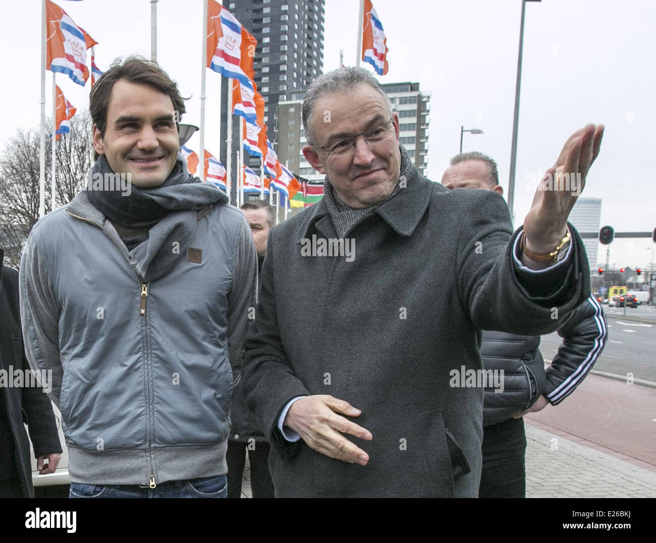 Roger Federer helps the mayor of Rotterdam, Ahmed Aboutaleb and tournament organizer, Richard Krajicek, raise the flags outside of The Ahoy Hall to celebrate the opening of The ABN AMRO World Tennis Tournament. (Federer will play on Wednesday.  Featuring: Stock Photo