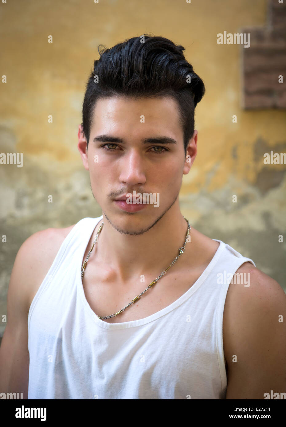 Headshot of attractive black haired young man outside, looking at camera Stock Photo