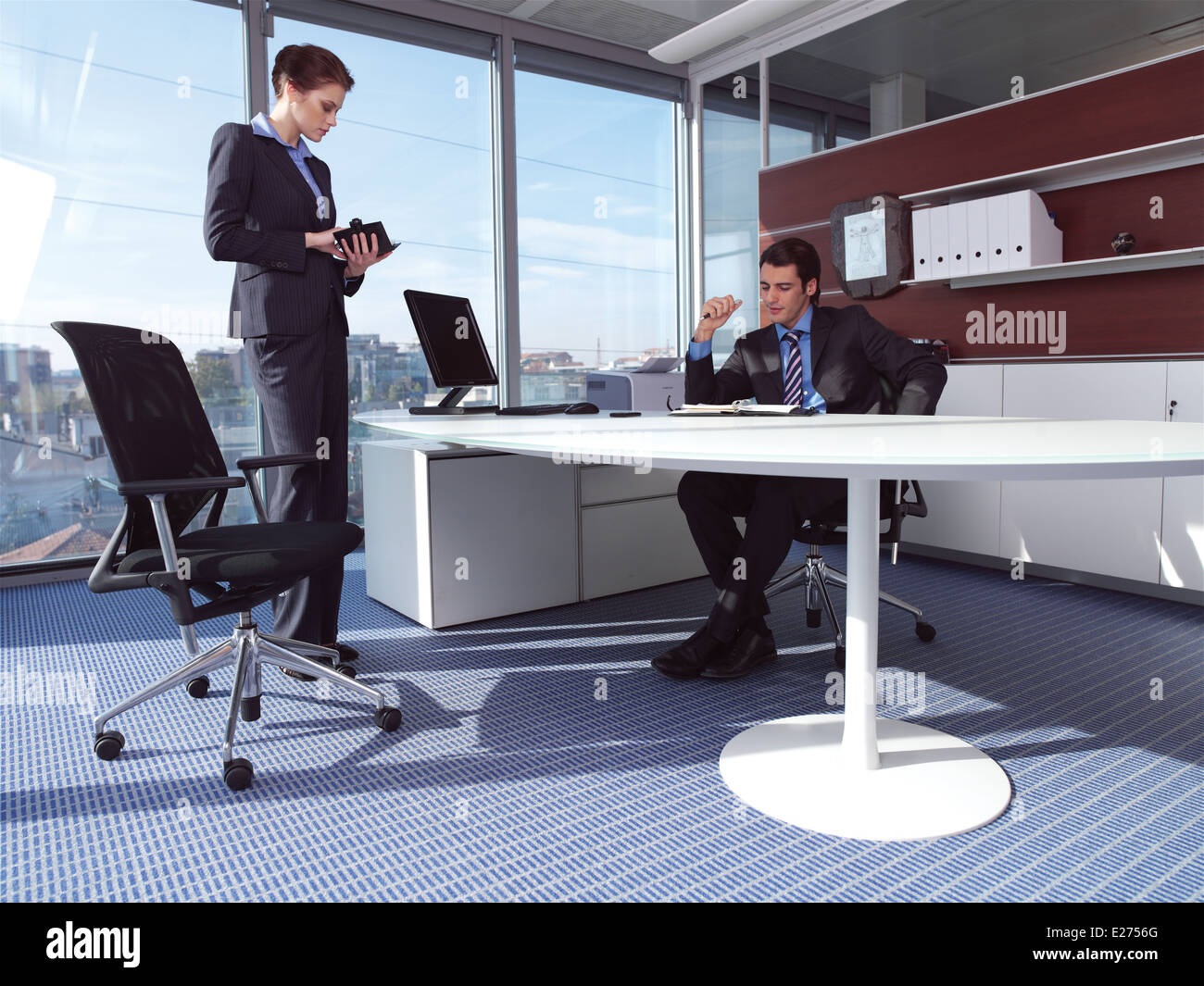 businesswoman and man working in her office Stock Photo - Alamy