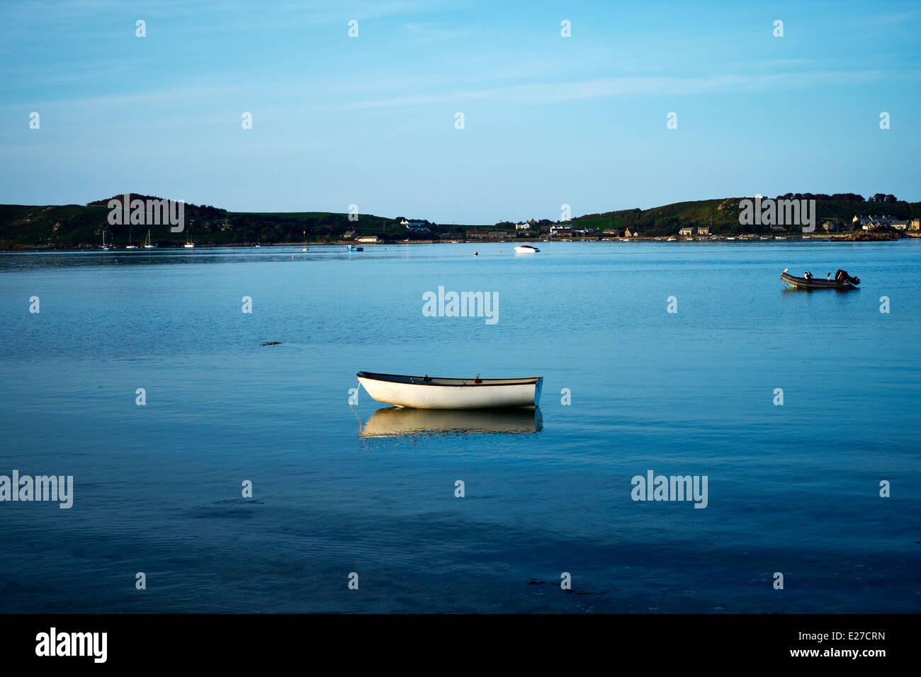 A rowing boat moored in on a still sea in Green Bay, Bryher, Isles of Scilly, 2014 Stock Photo