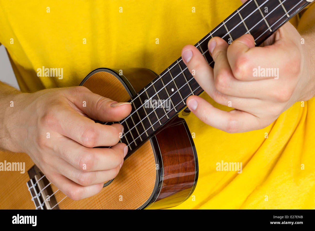 Man's hands playing ukulele Stock Photo
