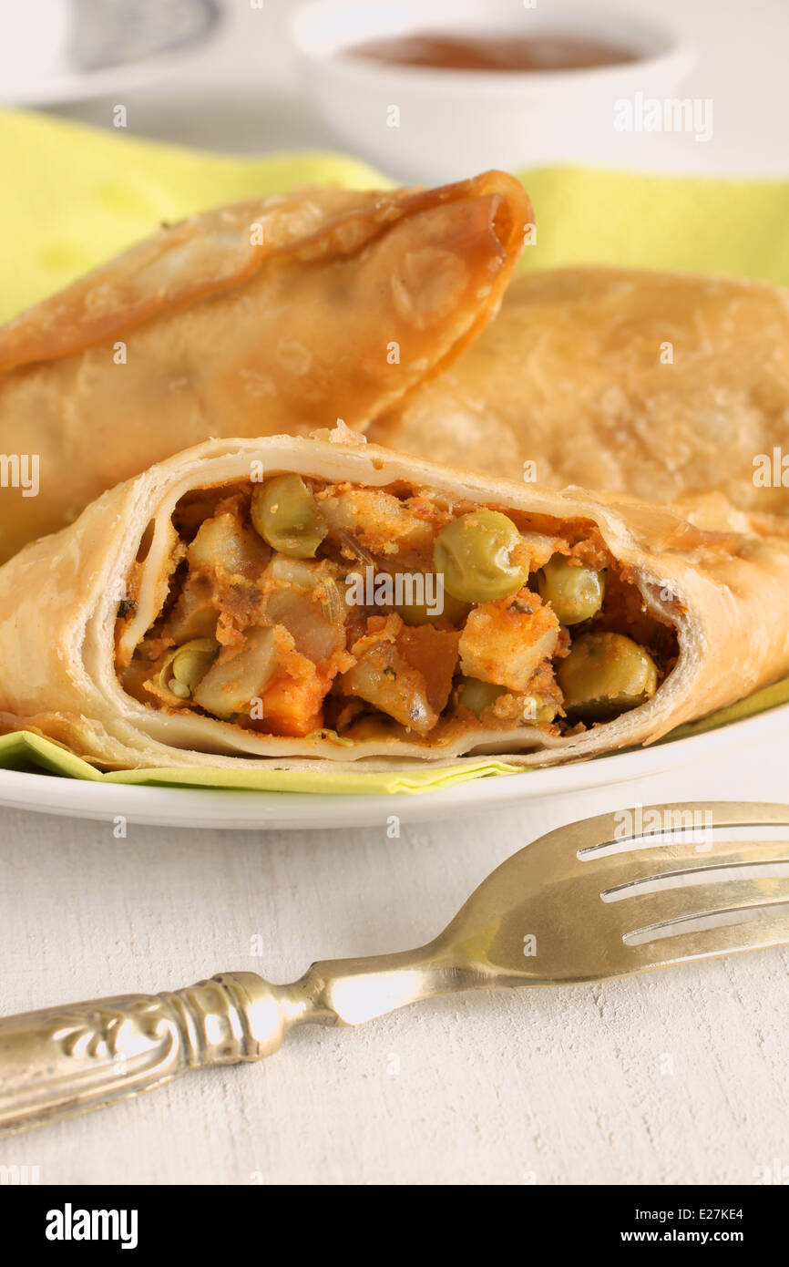 Vegetable Samosas a spicy blend of vegetables wrapped in a deep fried triangular pastry parcel Stock Photo