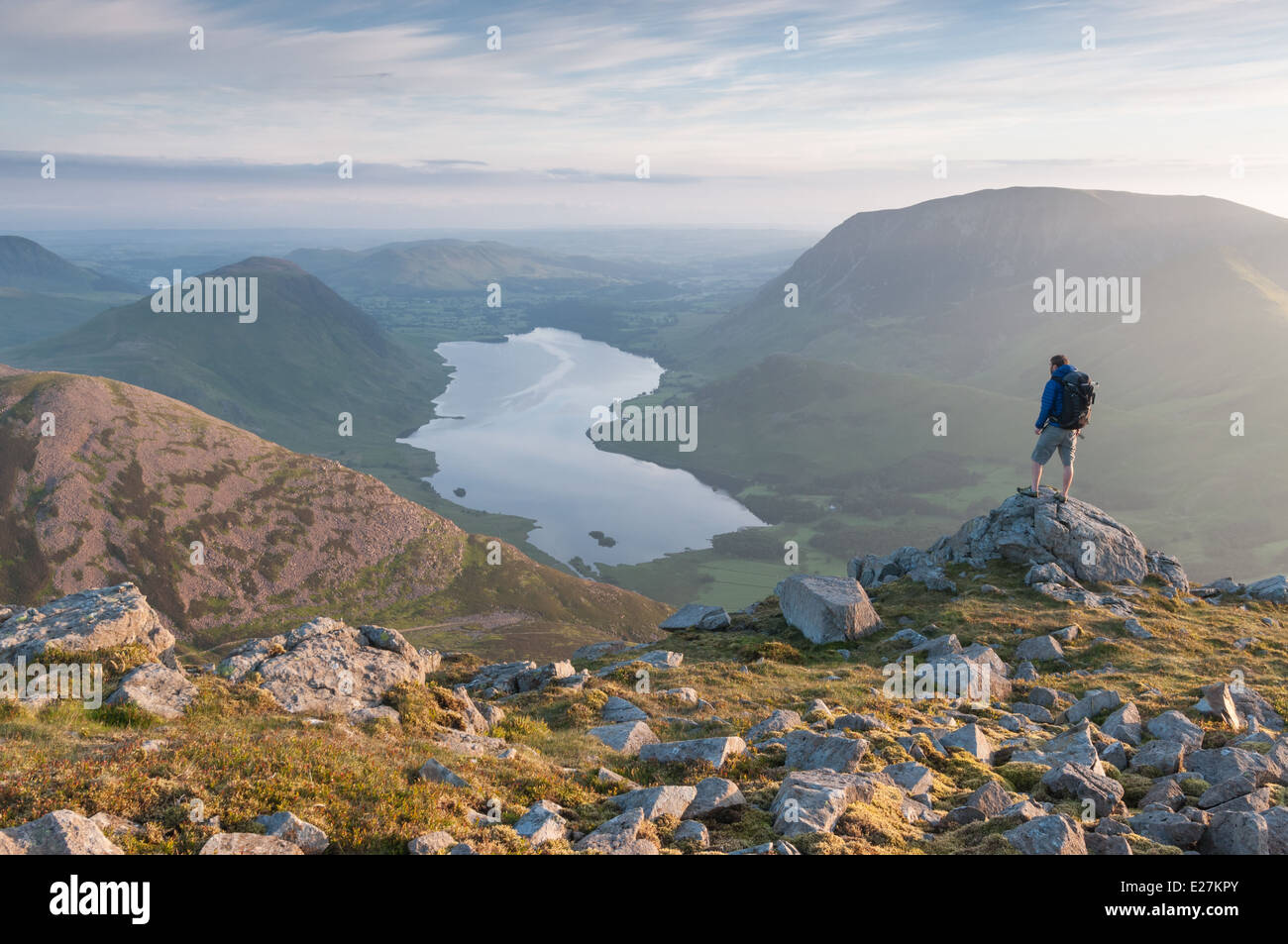 Walker on High Stile above Buttermere, overlooking Red Pike, Crummock Water, Mellbreak and Grasmoor, English Lake District Stock Photo