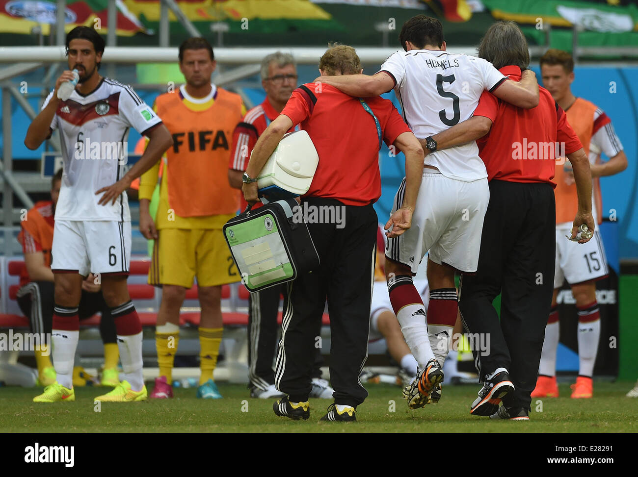 Salvador da Bahia, Brazil. 16th June, 2014. Mats Hummels (2-R) of Germany leaves the pitch injured and is assisted by team doctor Hans-Wilhelm Mueller-Wohlfahrt (R) and physiotherapist Klaus Eder during to the FIFA World Cup 2014 group G preliminary round match between Germany and Portugal at the Arena Fonte Nova Stadium in Salvador da Bahia, Brazil, 16 June 2014. Photo: Marcus Brandt/dpa Credit:  dpa picture alliance/Alamy Live News Stock Photo