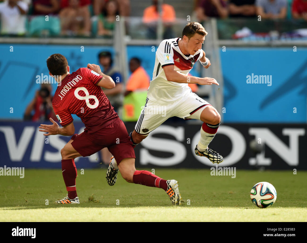 Salvador da Bahia, Brazil. 16th June, 2014. Mesut Oezil of Germany (R) vies for the ball with João Moutinho of Portugal during the FIFA World Cup 2014 group G preliminary round match between Germany and Portugal at the Arena Fonte Nova Stadium in Salvador da Bahia, Brazil, 16 June 2014. Credit:  dpa picture alliance/Alamy Live News Stock Photo