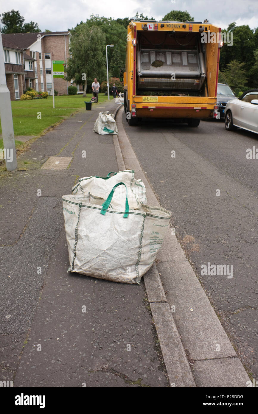 Garden waste in recycling bags at the roadside waiting to be collected