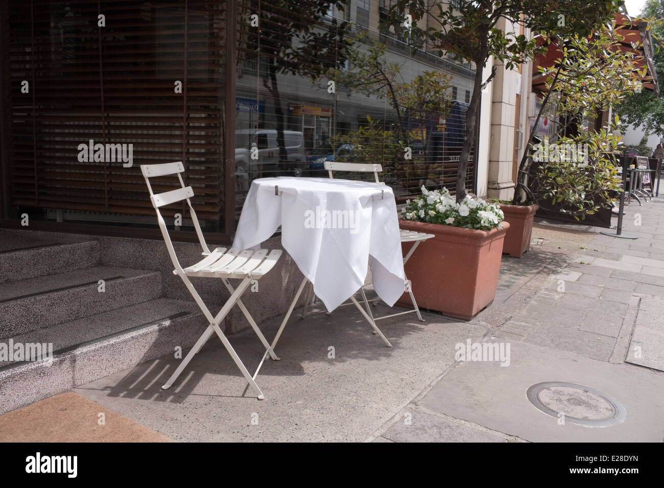 An empty table and chairs outside restaurant Stock Photo