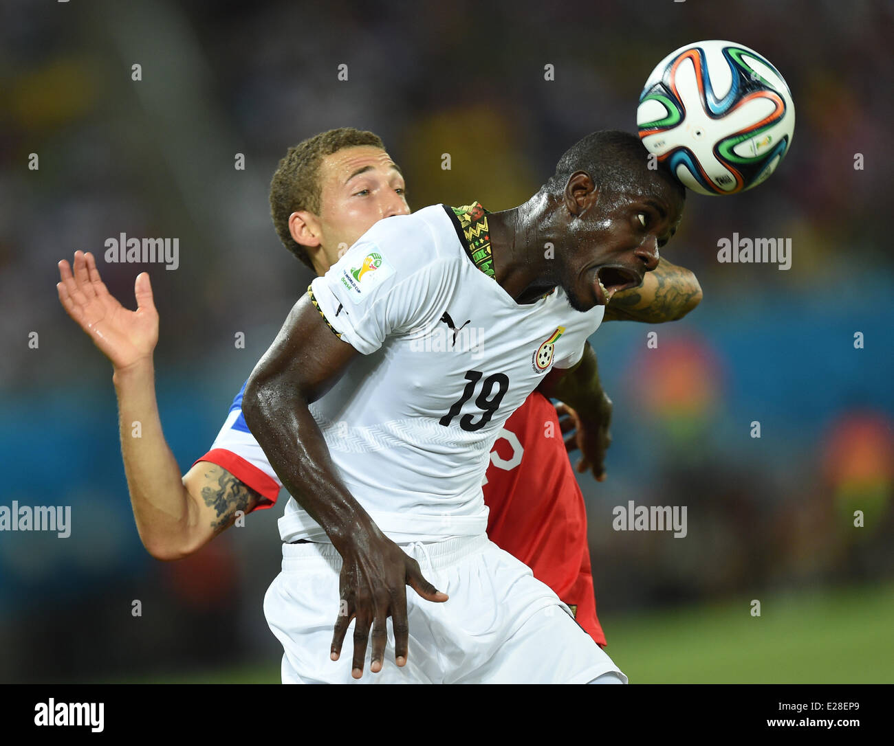 Natal, Brazil. 16th June, 2014. Fabian Johnson of USA in action against of Jonathan Mensah (R) Ghana during the FIFA World Cup 2014 group G preliminary round match between Ghana and the USA at the Estadio Arena das Dunas Stadium in Natal, Brazil, 16 June 2014. Credit:  dpa picture alliance/Alamy Live News Stock Photo