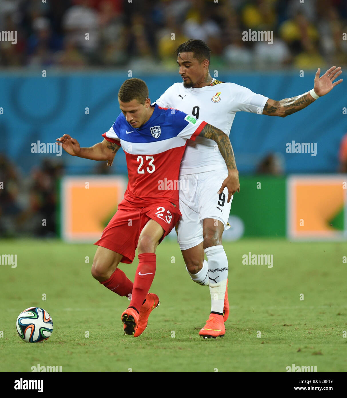 Natal, Brazil. 16th June, 2014. Fabian Johnson (L) of USA in action against Kevin Prince Boateng of Ghana during the FIFA World Cup 2014 group G preliminary round match between Ghana and the USA at the Estadio Arena das Dunas Stadium in Natal, Brazil, 16 June 2014. Credit:  dpa picture alliance/Alamy Live News Stock Photo