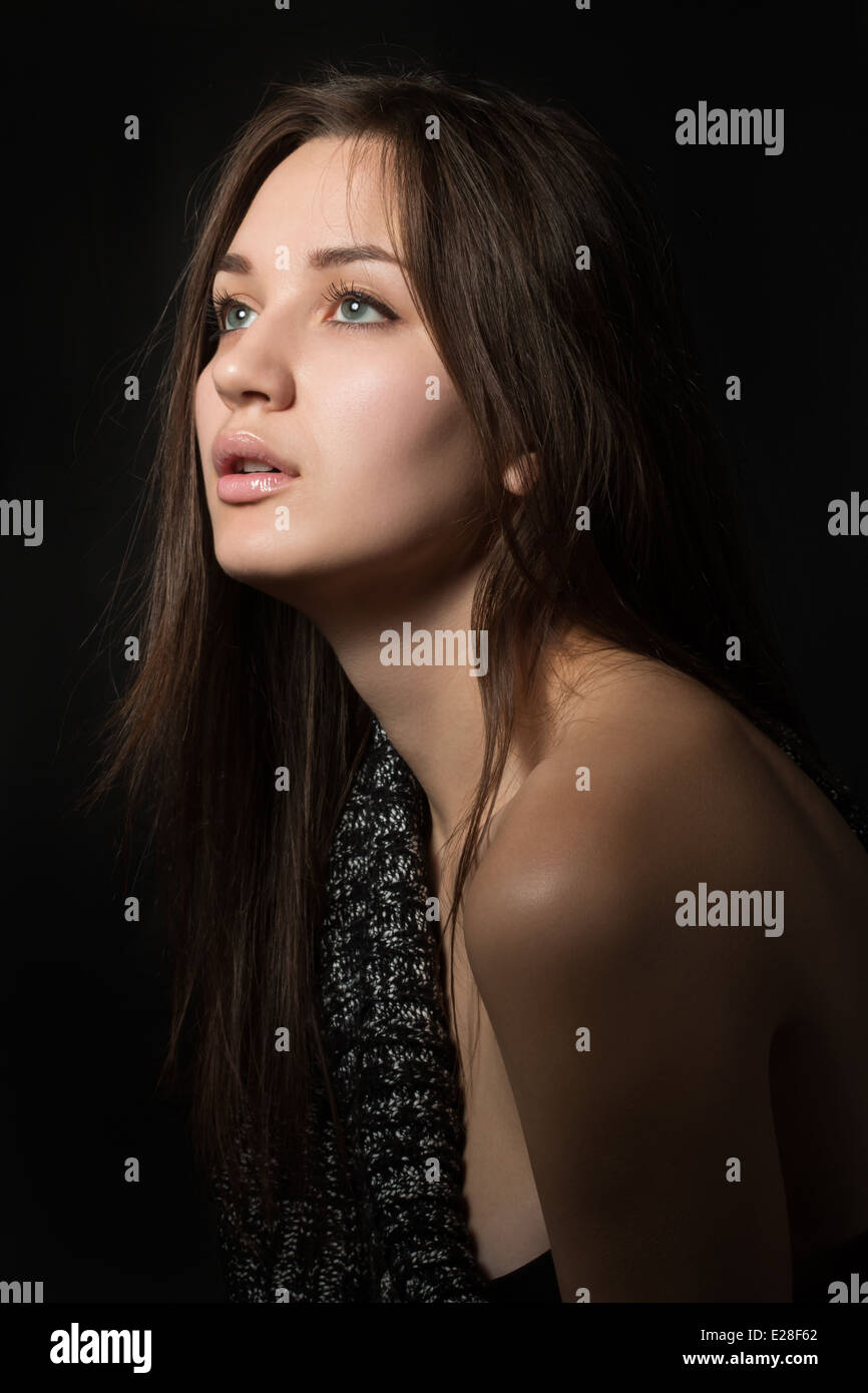 Portrait of young lonely woman in dark room Stock Photo Alamy