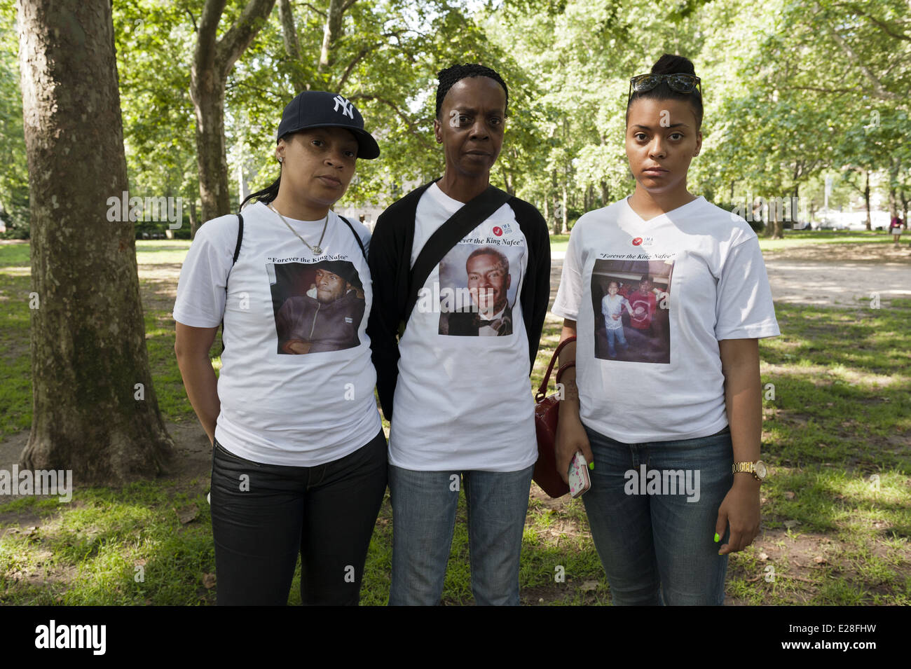 Grandmother, aunt, and cousin of gun violence victim wear his photo at The Second Annual Brooklyn Bridge March and Rally to End Gun Violence, 2014. Stock Photo