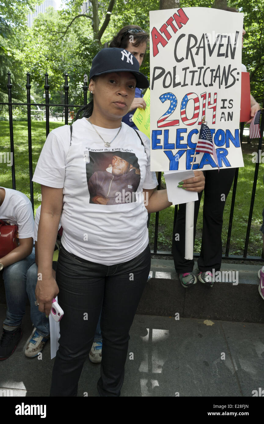 Woman at rally for gun control at City Hall in NYC wears picture of her 21 y.o. nephew who was a victim of gun violence. Stock Photo