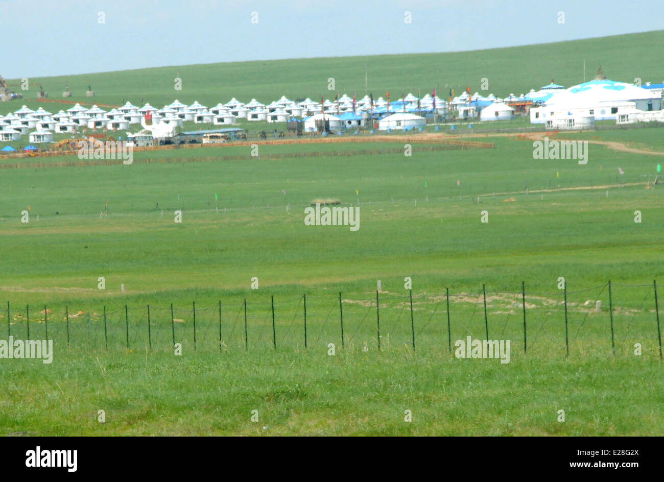 Hulun Buir, China's Inner Mongolia Autonomous Region. 16th June, 2014. Mongolian yurts are seen on the grassland of Hulun Buir, north China's Inner Mongolia Autonomous Region, June 16, 2014. Grass has been flourishing in Hunlun Buir due to sufficient rainfall and warm weather since June. Credit:  Li Yunping/Xinhua/Alamy Live News Stock Photo