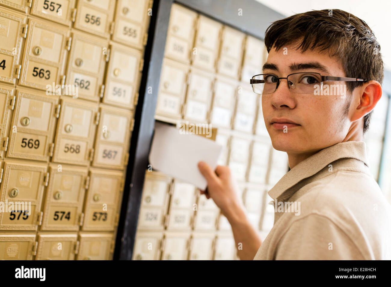 College student checking mail at mailboxed Stock Photo - Alamy