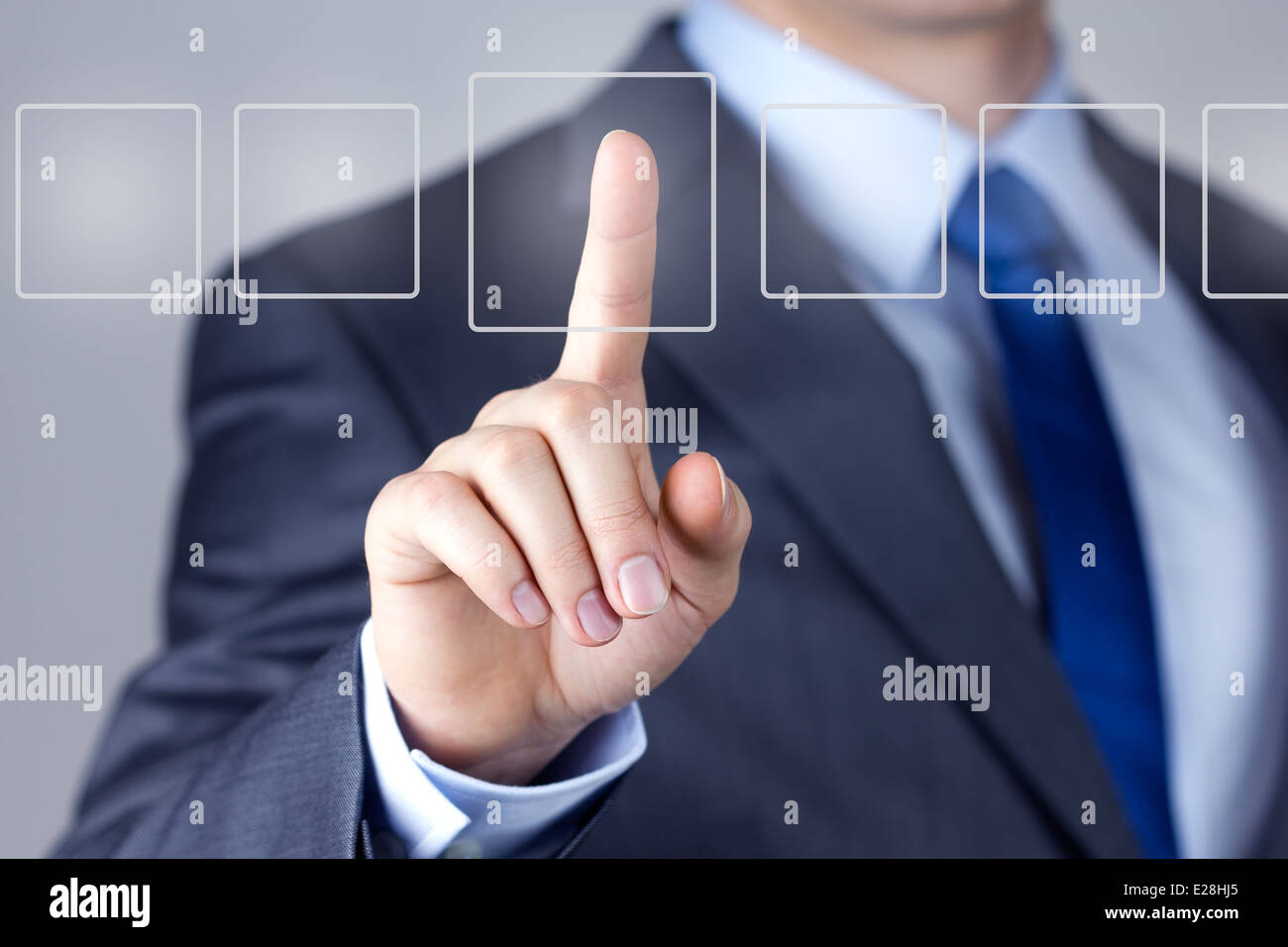 Businessman pushing on a touch screen interface Stock Photo