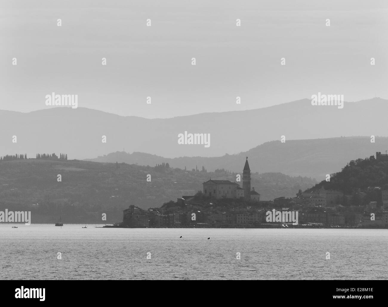 Misty early morning skyline of Piran in Slovenia from the sea Stock Photo