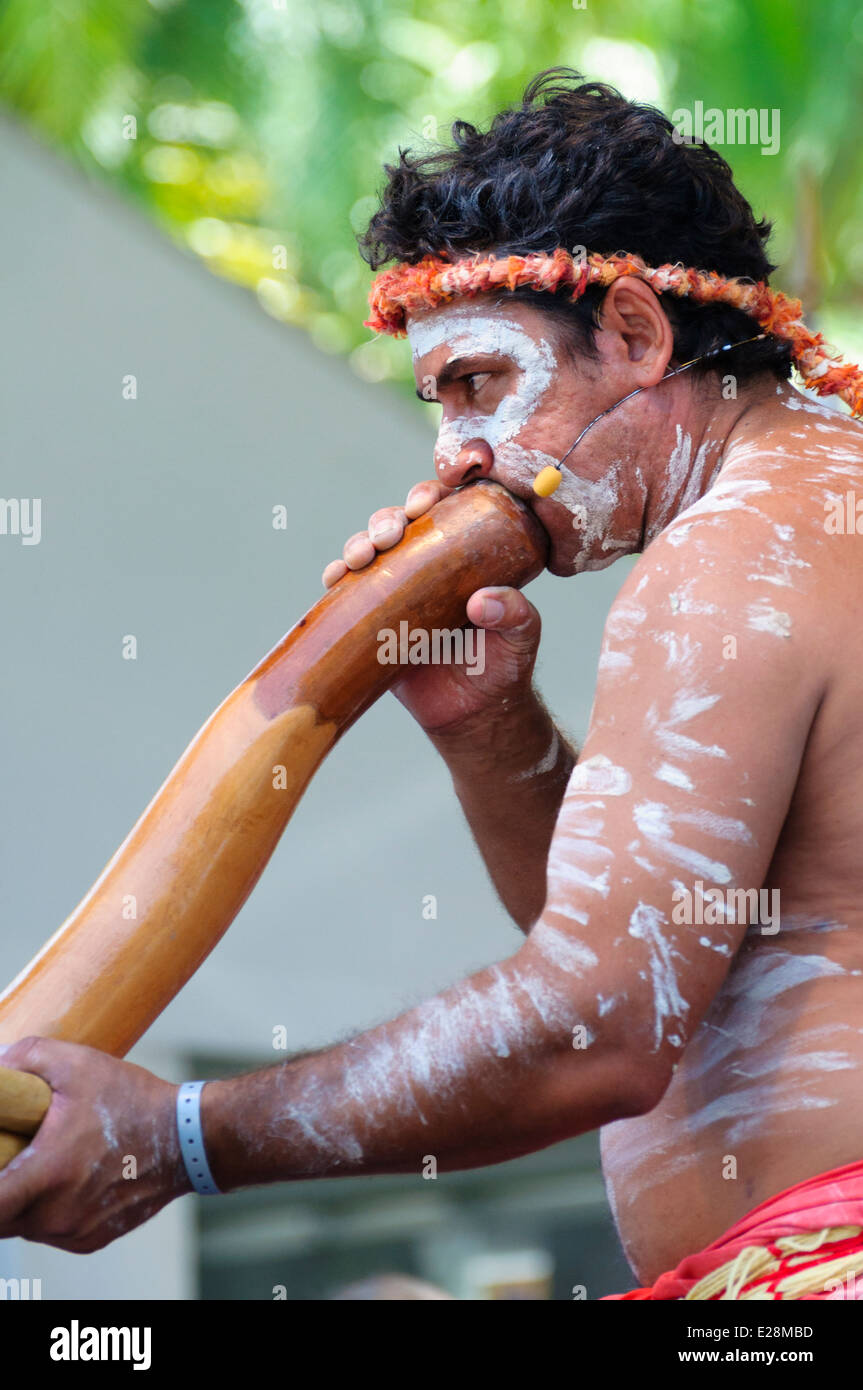 Australian Aborigine man in body paint playing a didgeridoo; Aboriginal culture; native Australian; Australia; traditional musical instrument; Stock Photo