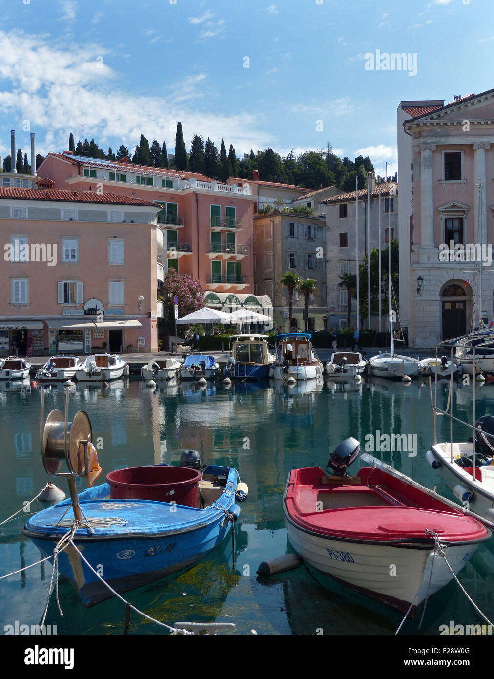 The harbour or marina in Piran, Slovenia with red and blue boats Stock Photo