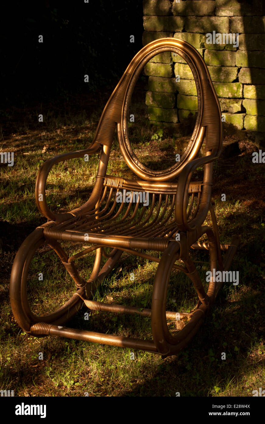 Cane Rocking Chair in Garden Stock Photo - Alamy