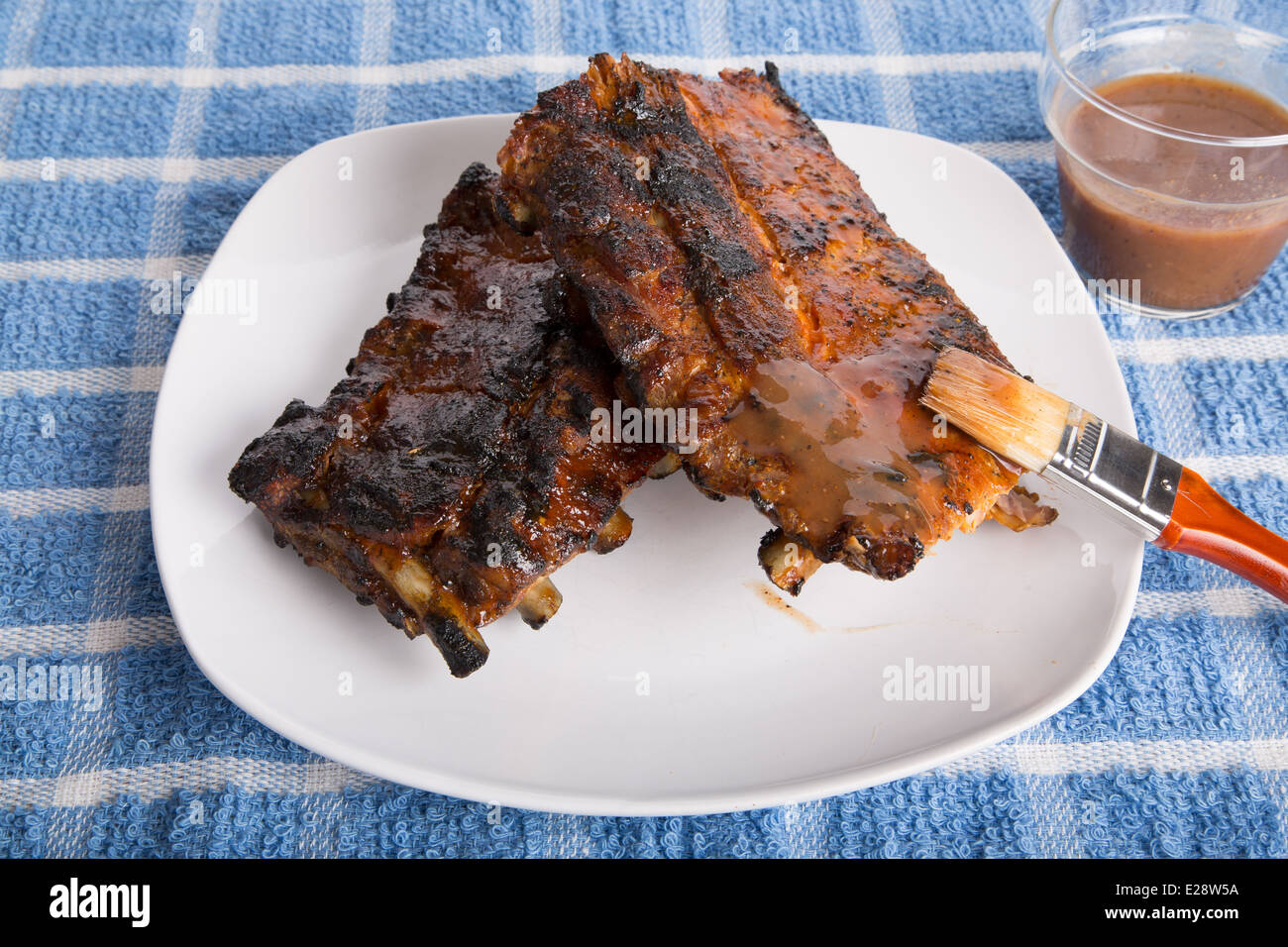 Barbecue spare ribs on a white place with peppery sauce Stock Photo - Alamy