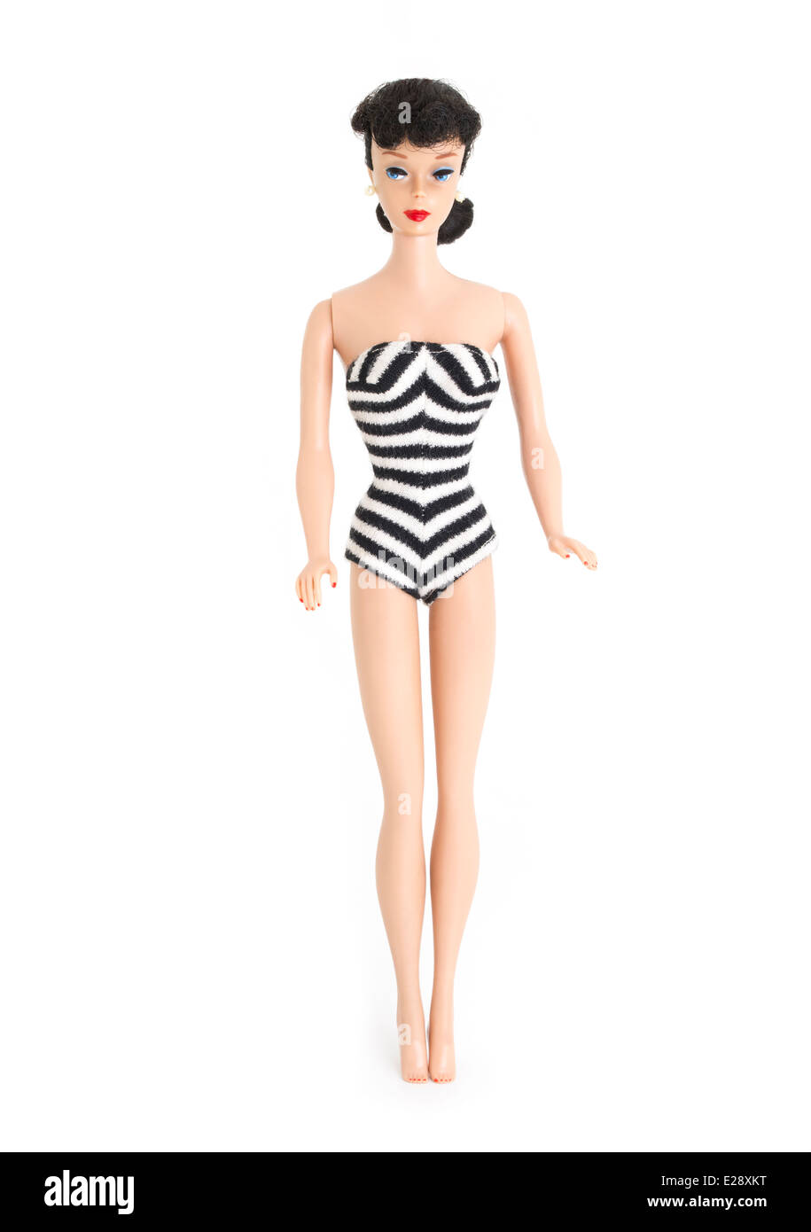 Barbie fashion doll by Mattel first created 1959 brunette, ponytail, black and white zebra swimsuit, straight leg.1961 pearl earrings , eyebrows Stock Photo