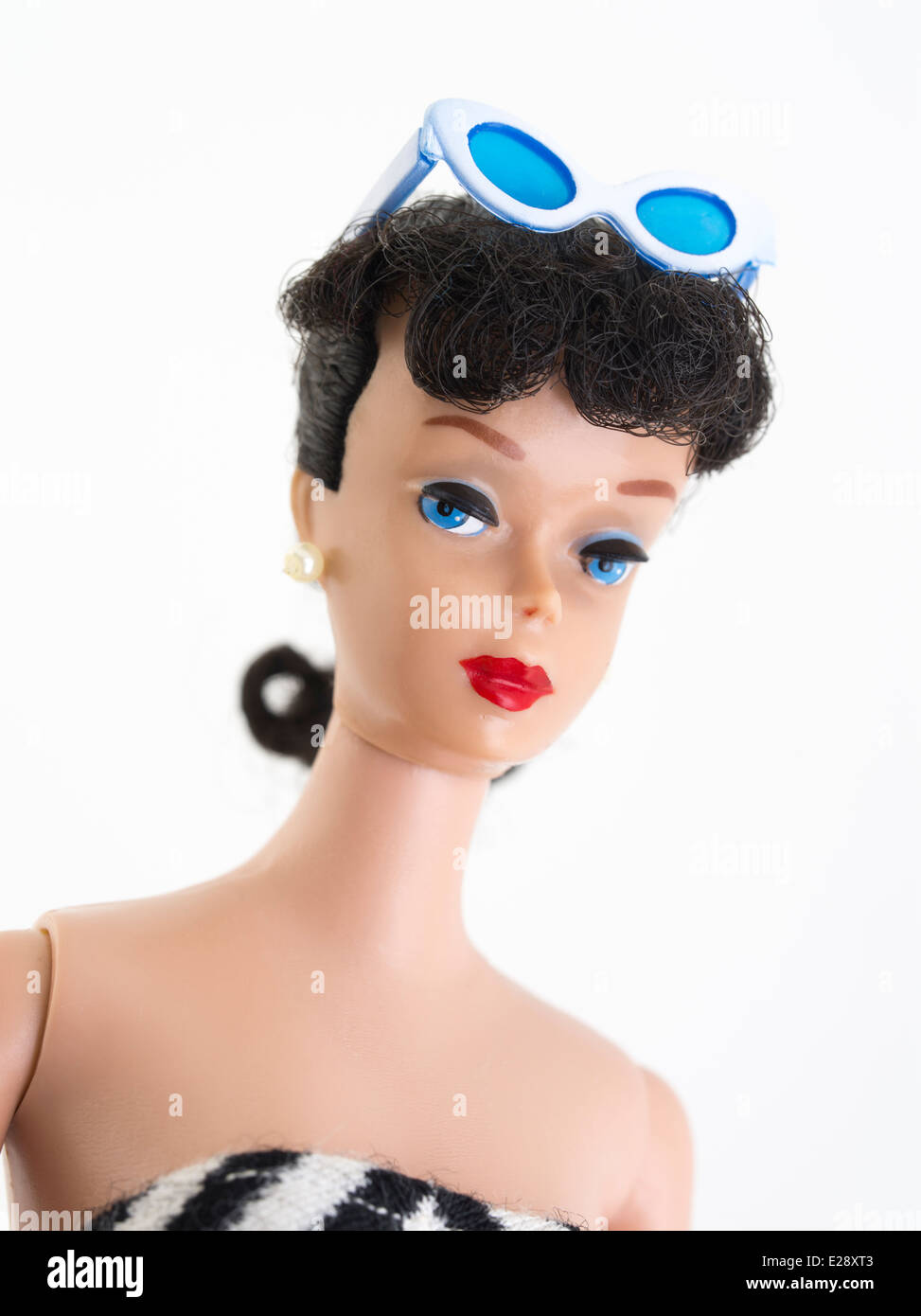 Barbie fashion doll by Mattel first created 1959 brunette, ponytail, black and white zebra swimsuit, straight leg.1961 pearl earrings , eyebrows Stock Photo