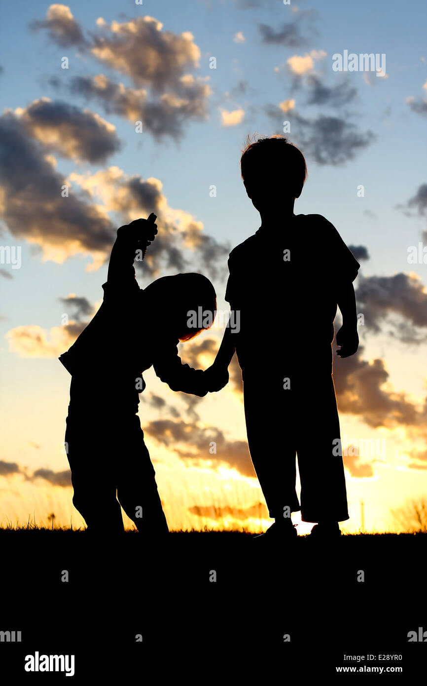 Two boys holding hands hi-res stock photography and images - Alamy