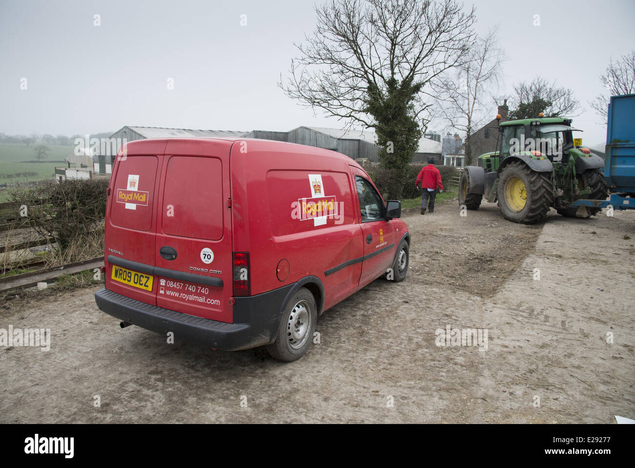 Royal Mail van and postman, delivering post to farm, Preston, Lancashire, England, March Stock Photo