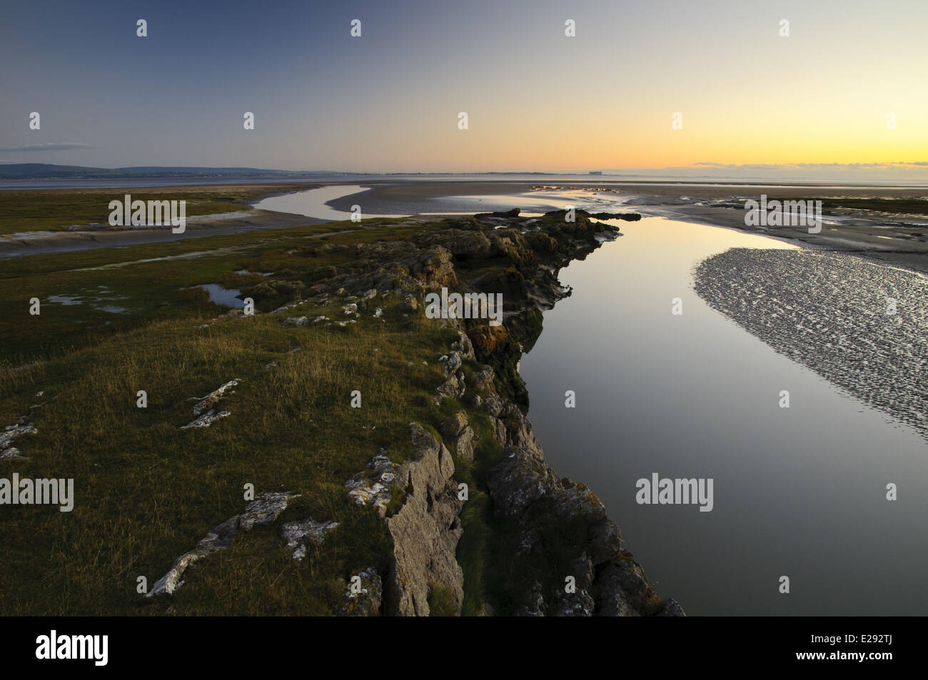 View of spit projecting into bay at dusk, Humphrey Head, Morecambe Bay, Cumbria, England, December Stock Photo