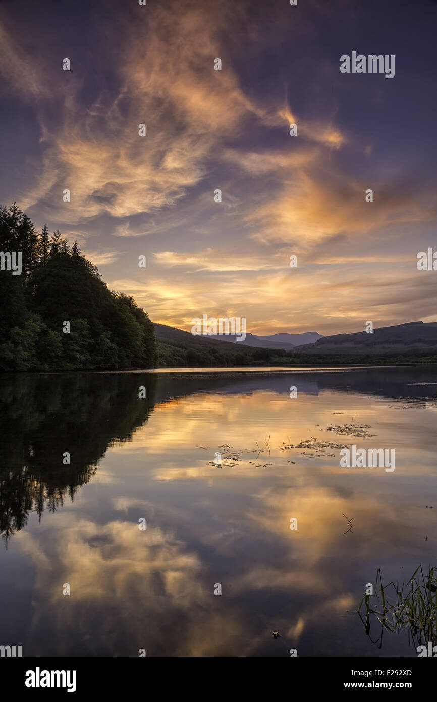 View of reservoir and distant hills at sunset, Penyfan, Taf Fechan Reservoir, Brecon Beacons N.P., Merthyr Tydfil, Wales, July Stock Photo