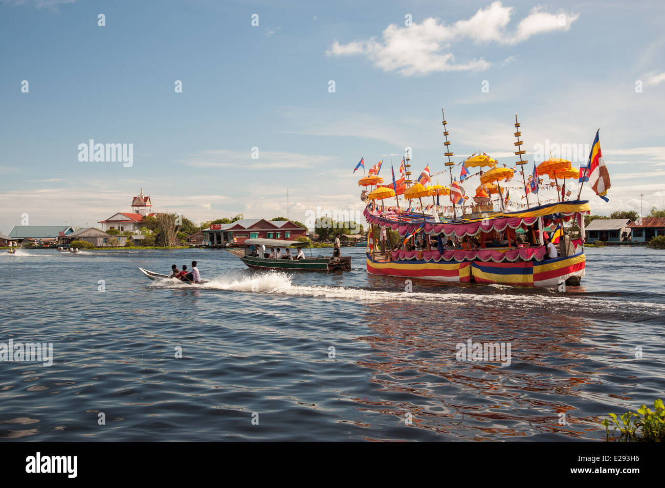 Decorated boat brings devotees to the temple for a Buddhist festival on the Tonle Sap Lake Stock Photo