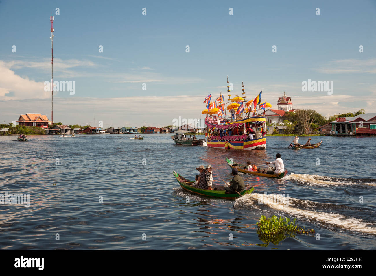 Decorated boat brings devotees to the temple for a Buddhist festival on the Tonle Sap Lake Stock Photo