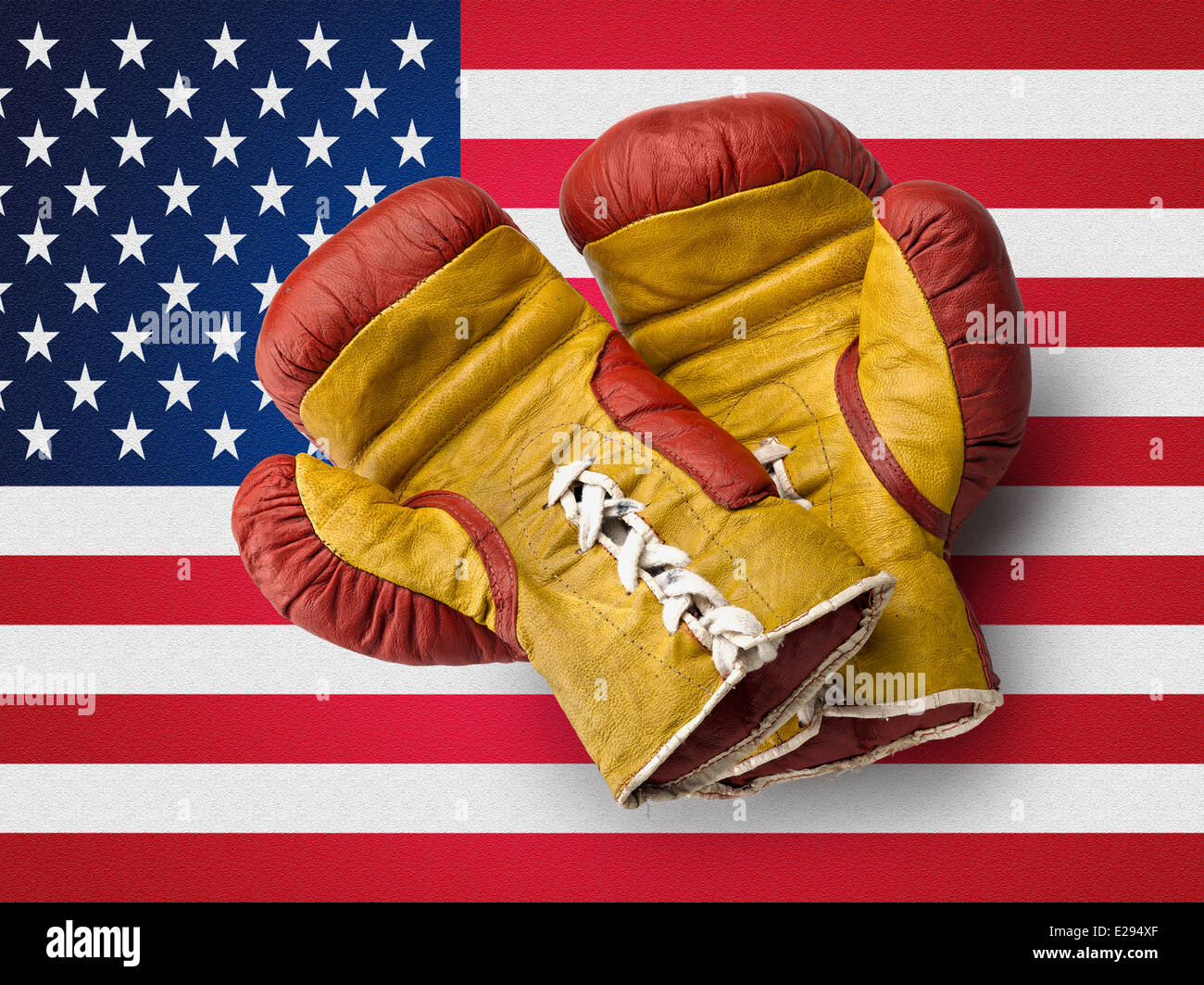 Old red and Yellow boxe gloves on USA flag Stock Photo