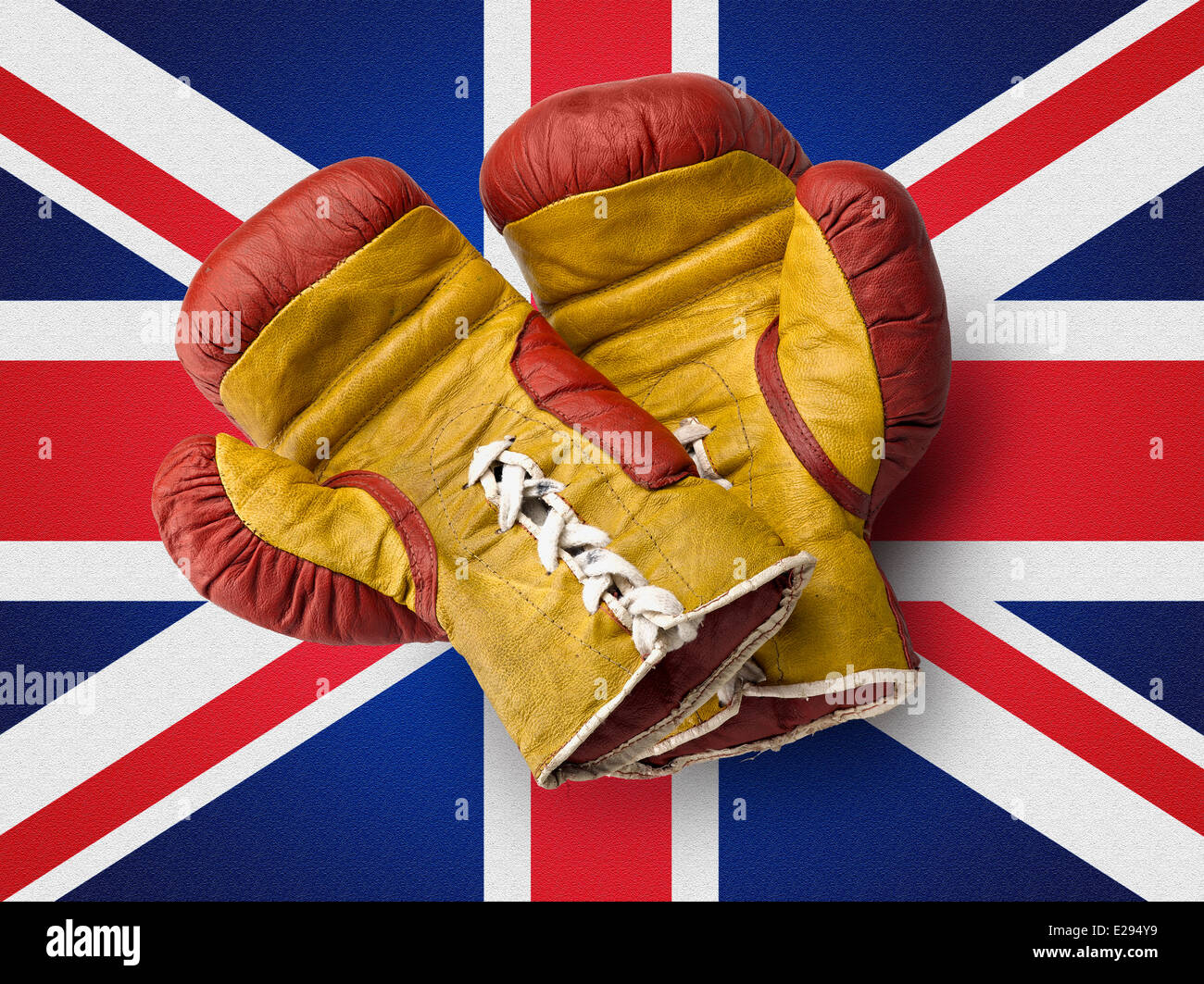 Old red and Yellow boxe gloves on union jack flag Stock Photo