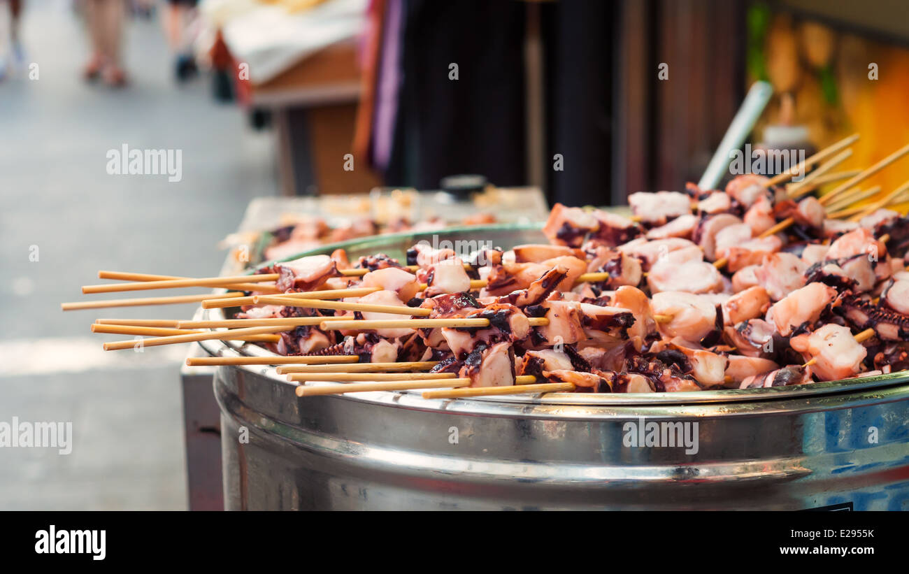 Squid skewers on a grill at the streetmarket in Insadong, Seoul. Stock Photo