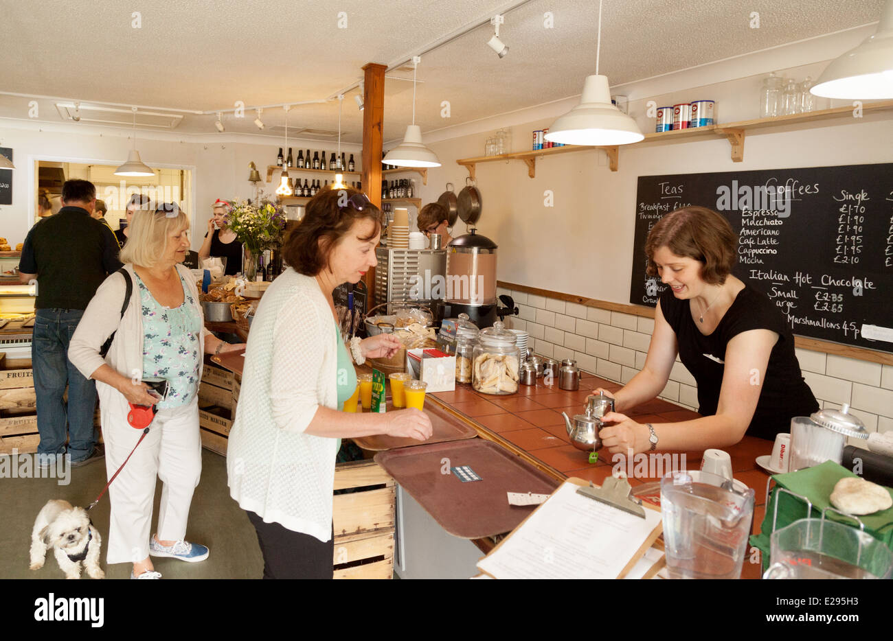 Waitress serving tea being served at the Hive Beach cafe, Burton Bradstock, Dorset England UK Stock Photo