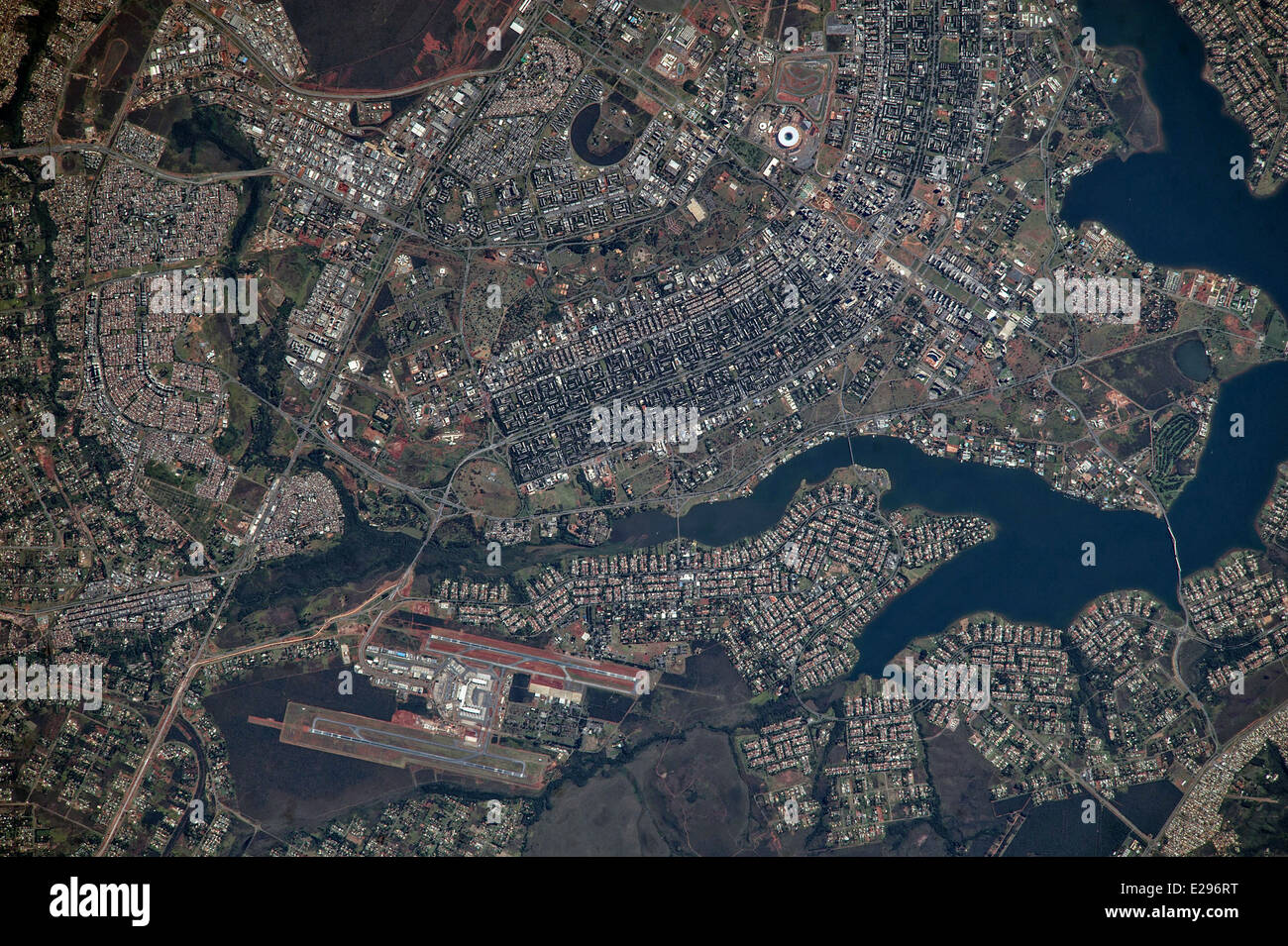 View from the International Space Station of the Brasilia World Cup Stadium (top center) May 28, 2014 in Brasilla, Brazil. The new roof appears as a brilliant white ring in this image. The stadium is one of Brasilia's largest buildings. Renovation began in 2010 and it is now the second most expensive stadium in the world, after Wembley Stadium in London, UK. Brasilia's international airport can be seen lower left on the far side of Lake Paranoa. Brasilia is widely known for its modern building designs and city layout. Stock Photo