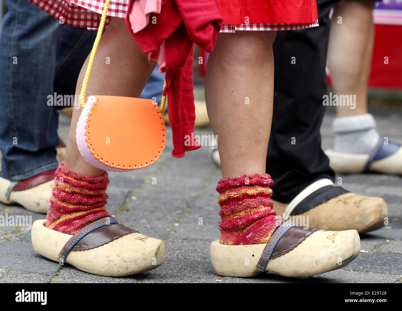 Neukirchen-Vluyn, Germany. 16th June, 2014. People walk in wooden clogs for  the 'Klompen Ball' in Neukirchen-Vluyn, Germany, 16 June 2014. Klompen is  the Dutch word for clogs. Soft woods are suitable for