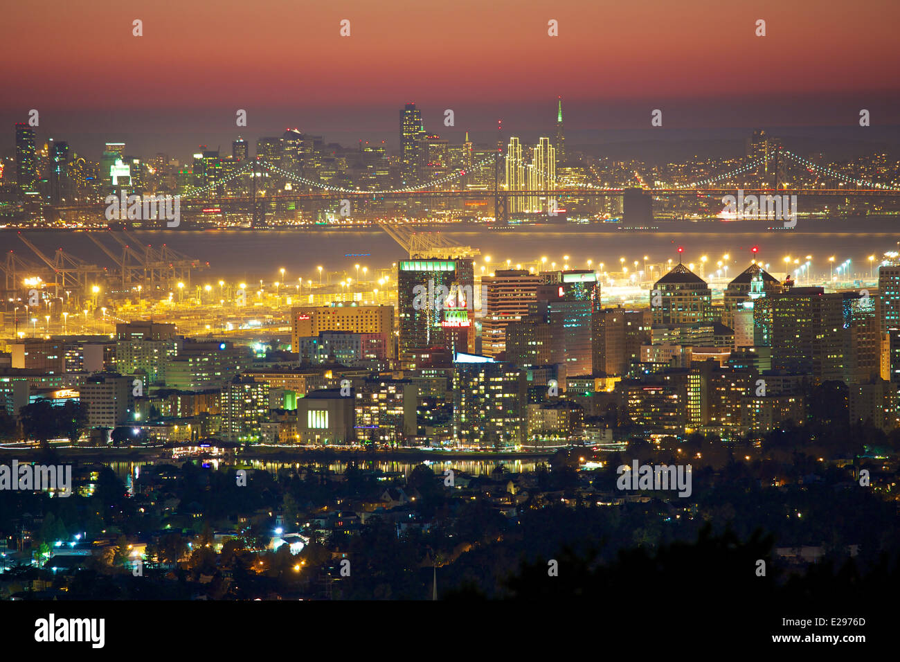 A rare view of the Oakland and San Francisco skylines at night along with the Bay Bridge Stock Photo