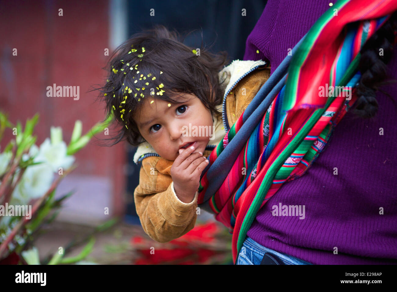 A portrait of a young Quechua boy in a market in a small village in the Andes, Peru, South America Stock Photo