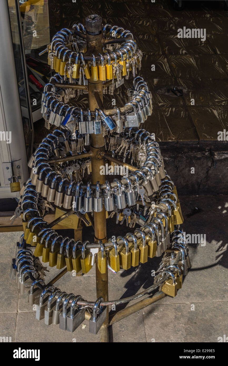 Padlocks with keys on display on a multitiered rack outside of a