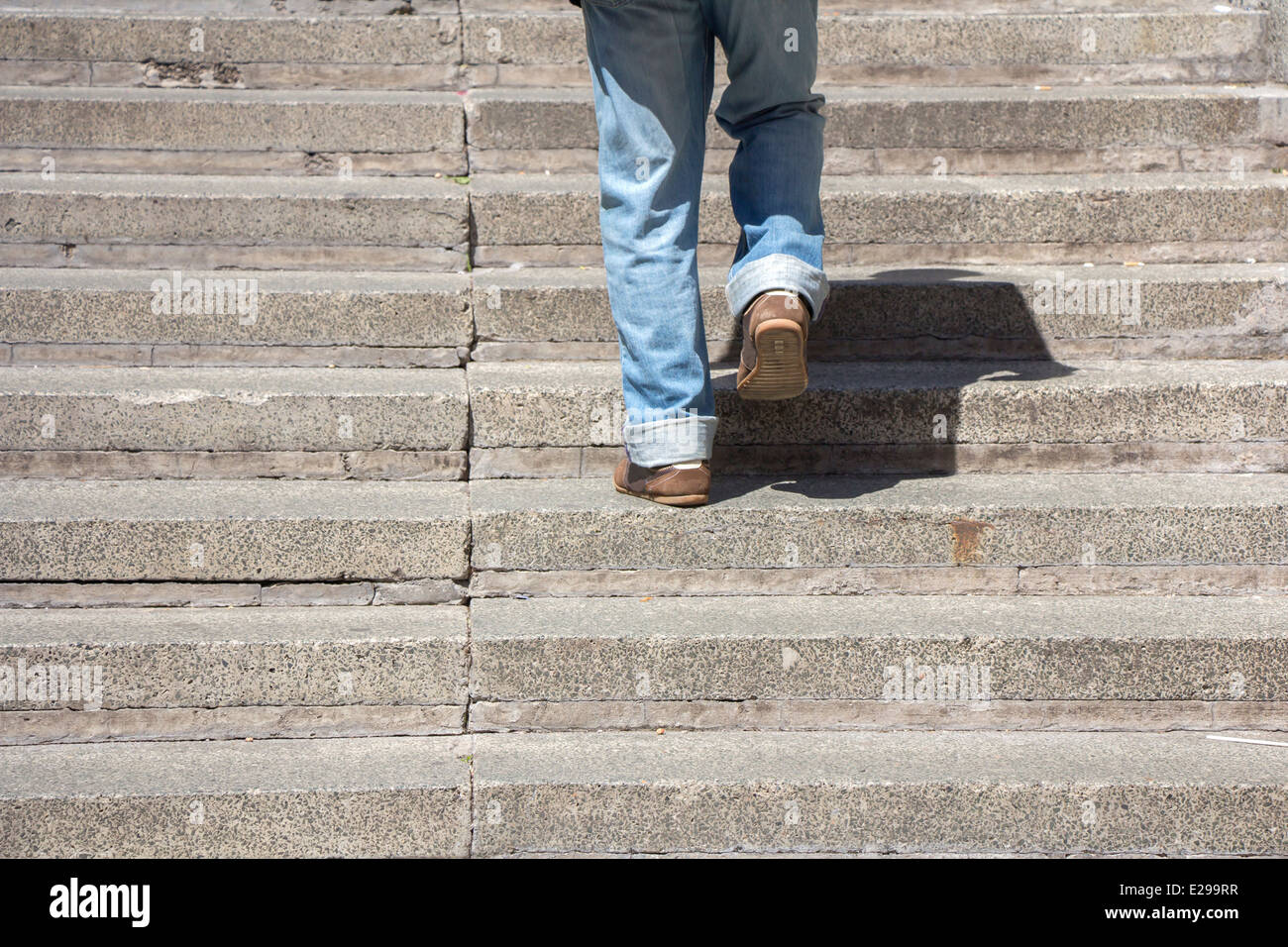Man climbs on a concrete stairs Stock Photo