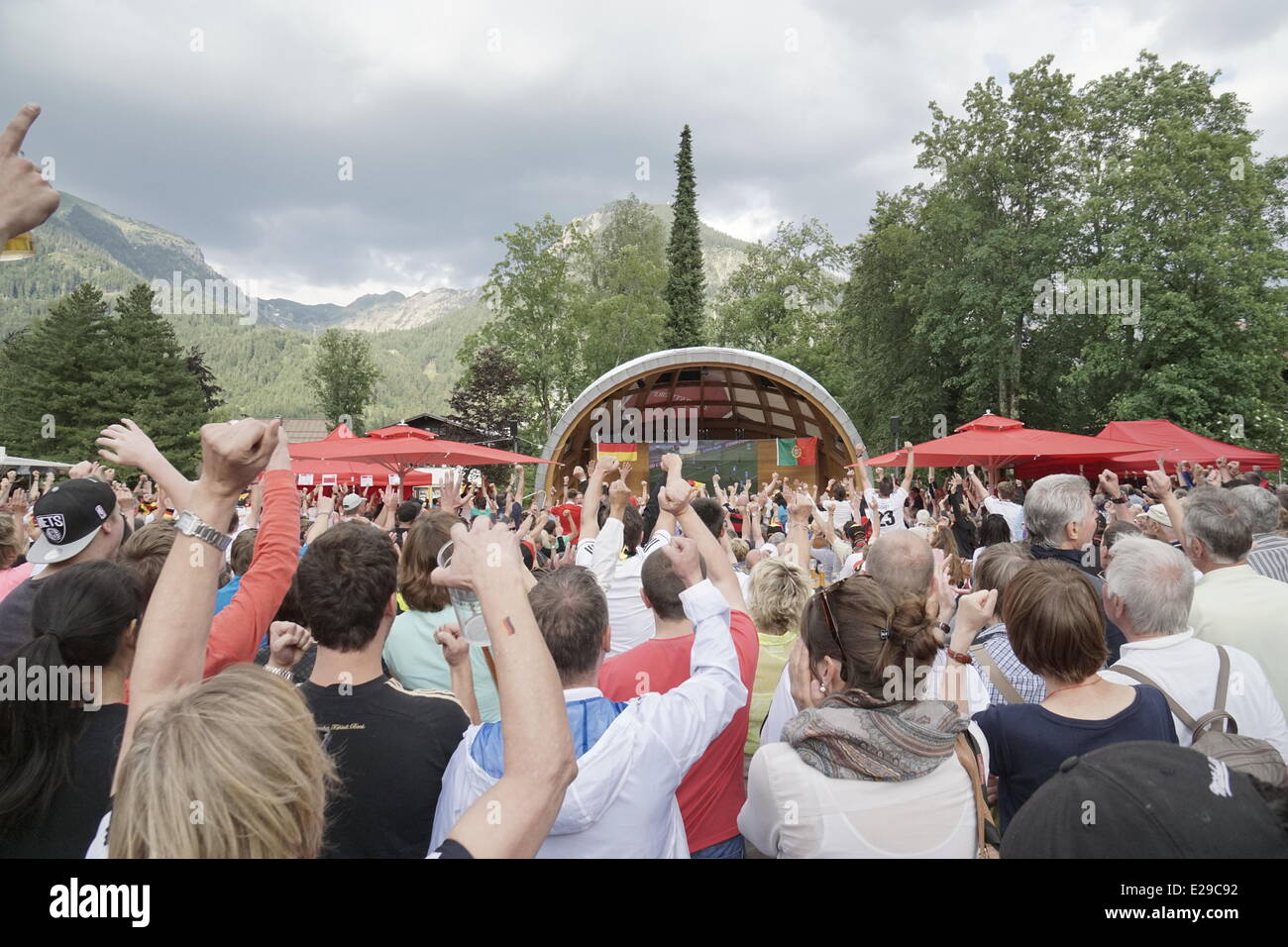 OBERSTDORF GERMANY JUNE 16: Spectators of the 2014 Soccer World cup in Brazil  celebrating the game between Germany and Portugal at the famous winter sports resort Oberstdorf with its picturesque mountains in the background Credit:  mezzotint alamy/Alamy Live News Stock Photo